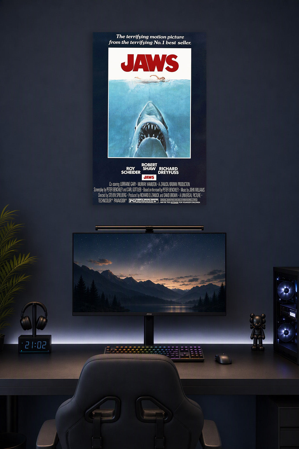 Jaws Movie Poster in a gaming desk setup above a monitor.