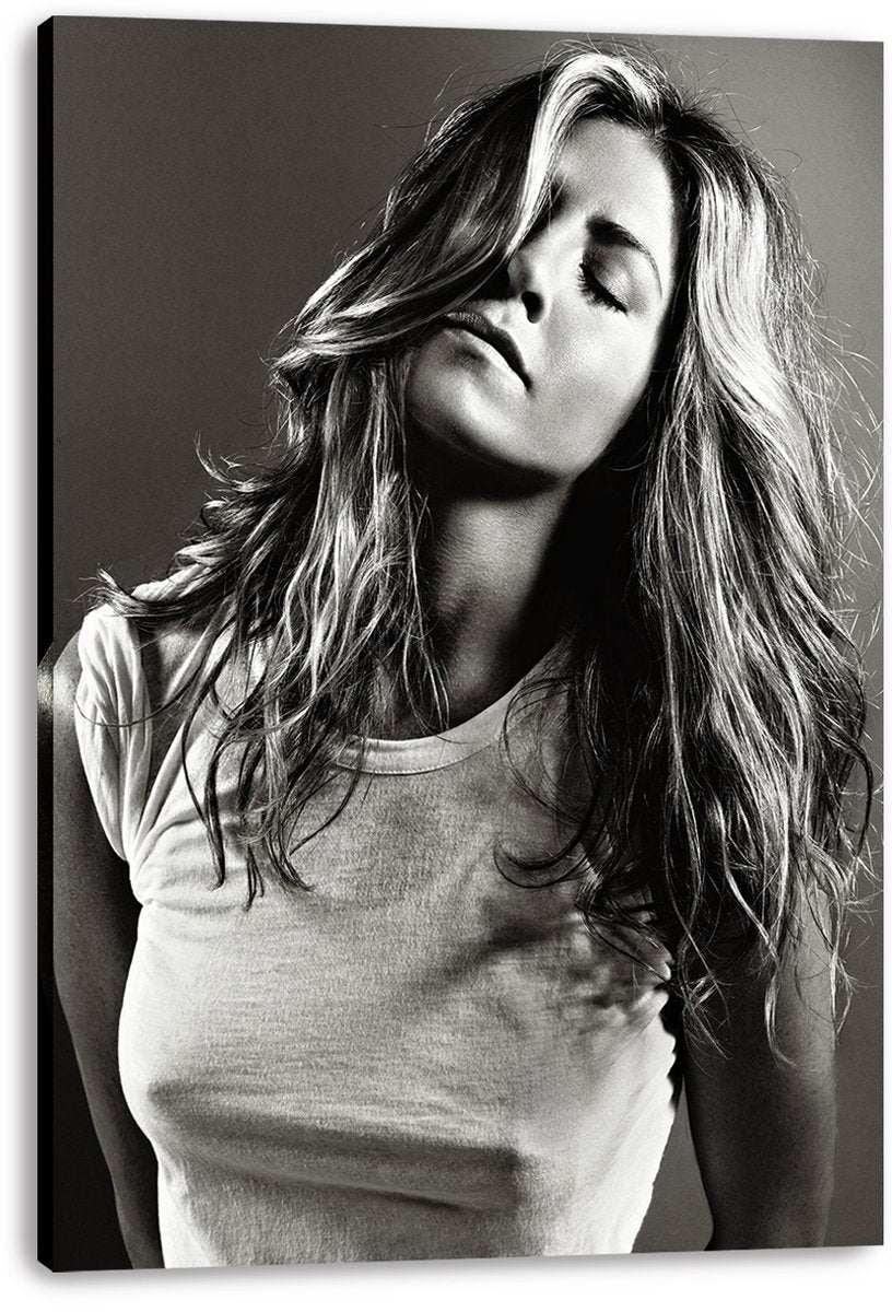 Jennifer Aniston canvas wall art print displays a monochrome portrait of her with flowing hair, closed eyes, and a white T-shirt.