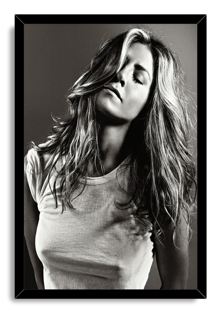 Jennifer Aniston framed wall art print presents a black-and-white portrait with windswept long hair and closed eyes in a black frame.