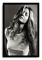Jennifer Aniston framed wall art print presents a black-and-white portrait with windswept long hair and closed eyes in a black frame.