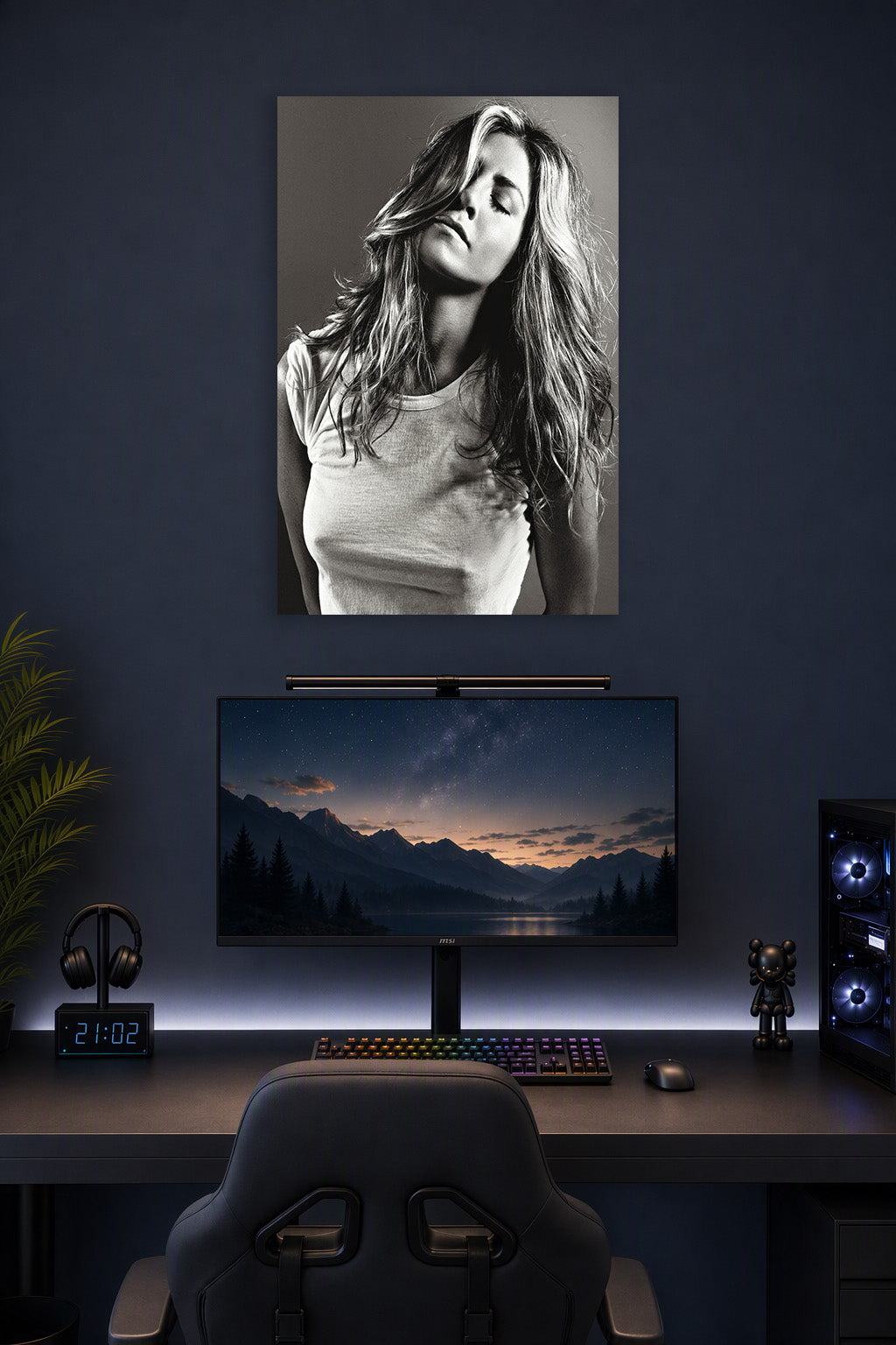 Jennifer Aniston in a gaming desk setup above a monitor.
