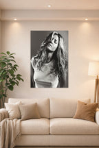 Jennifer Aniston in a bright living room above a beige sofa.