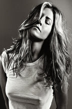 Jennifer Aniston wall art print features a black-and-white portrait with her eyes closed, long tousled hair, and a white T-shirt.