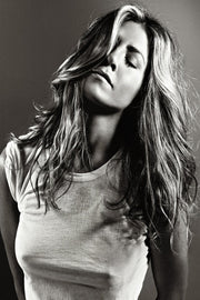 Jennifer Aniston wall art print features a black-and-white portrait with her eyes closed, long tousled hair, and a white T-shirt.