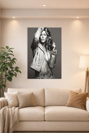 Jennifer Aniston in a bright living room above a beige sofa.