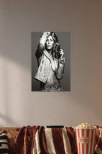 Jennifer Aniston in a cozy movie room above a brown sofa with popcorn.
