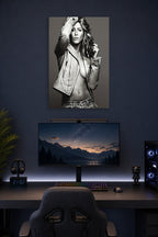 Jennifer Aniston in a gaming desk setup above a monitor.
