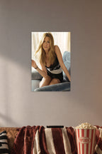 Jennifer Aniston in a cozy movie room above a brown sofa with popcorn.