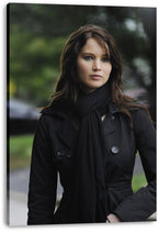 Jennifer Lawrence canvas wall art print featuring a close portrait in a black coat and scarf, displayed with wrapped canvas edges.