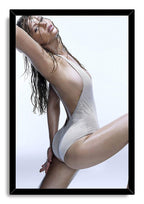 Jennifer Lawrence framed wall art print presents a wet-haired portrait in a white mesh swimsuit within a sleek black frame.