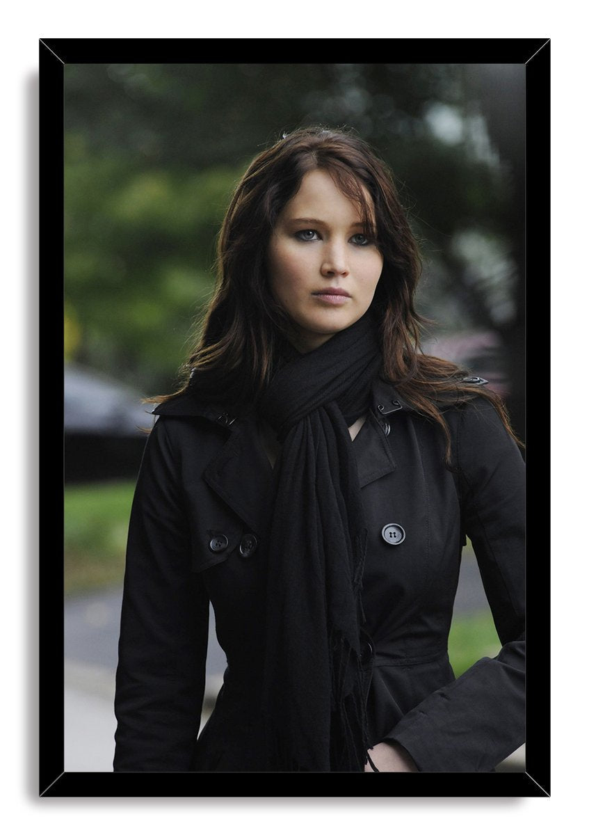 Jennifer Lawrence framed wall art print portraying the actress in a black trench coat and scarf, set in a glossy black rectangular frame.