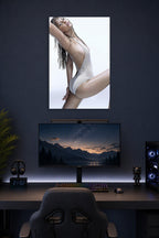 Jennifer Lawrence in a gaming desk setup above a monitor.