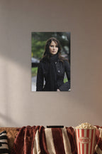 Jennifer Lawrence in a cozy movie room above a brown sofa with popcorn.