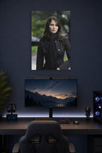 Jennifer Lawrence in a gaming desk setup above a monitor.