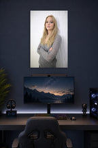 Jennifer Lawrence in a gaming desk setup above a monitor.