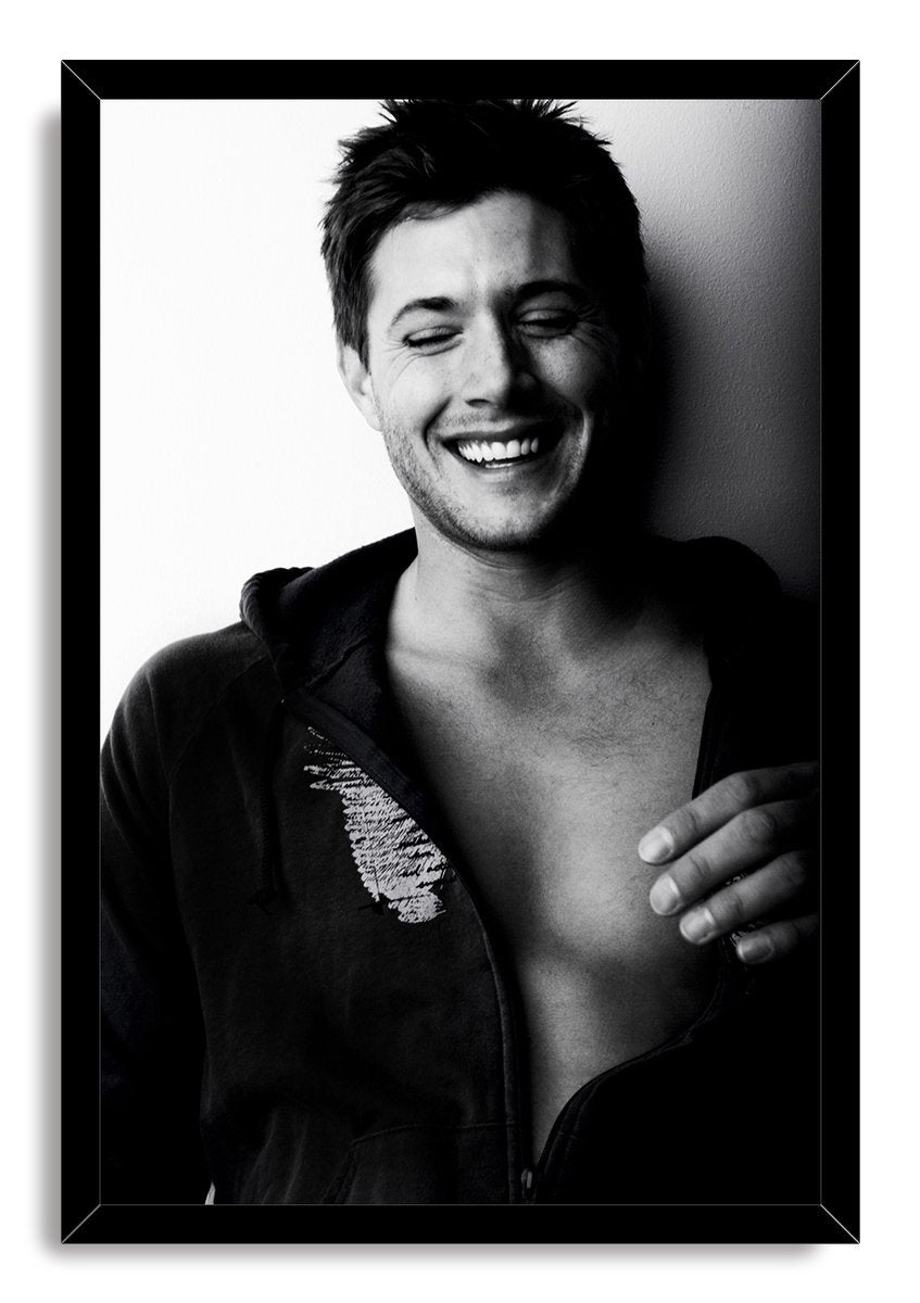 Jensen Ackles framed wall art print displays a black-and-white laughing portrait in a glossy black rectangular frame.