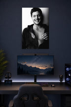 Jensen Ackles in a gaming desk setup above a monitor.