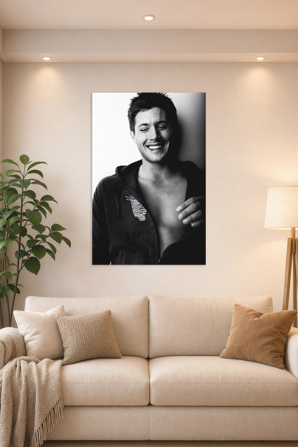 Jensen Ackles in a bright living room above a beige sofa.