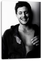 Jensen Ackles canvas wall art print presents a monochrome laughing portrait, with his open hoodie and hand across his chest.