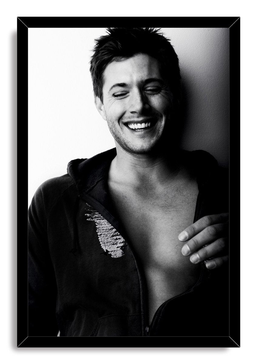 Jensen Ackles framed wall art print displays a black-and-white portrait of the actor smiling broadly with eyes closed.