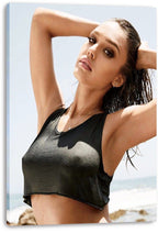 Jessica Alba canvas wall art print featuring a sunlit beach portrait in a black crop top, displayed with visible wrapped edges.