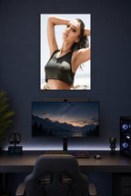 Jessica Alba in a gaming desk setup above a monitor.