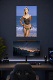 Jessica Alba in a gaming desk setup above a monitor.