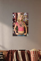 Jessica Simpson as Daisy Duke in a cozy movie room above a brown sofa with popcorn.