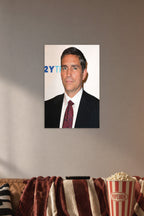 Jim Caviezel in a cozy movie room above a brown sofa with popcorn.