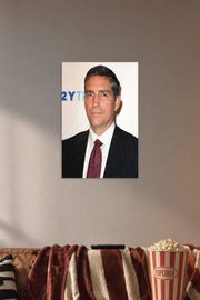Jim Caviezel in a cozy movie room above a brown sofa with popcorn.