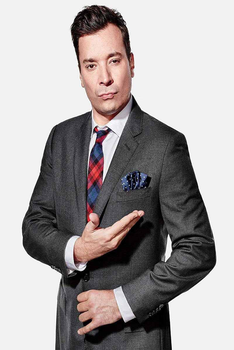 Jimmy Fallon poster portrait in a gray suit, plaid red and blue tie, and navy pocket square against white.