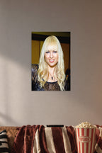 Joanna Angel Portrait in a cozy movie room above a brown sofa with popcorn.