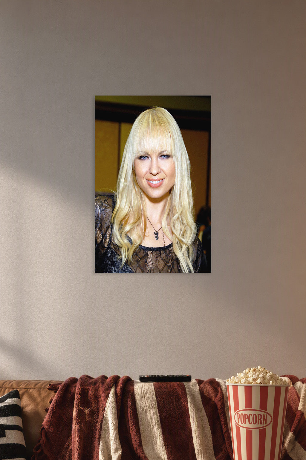 Joanna Angel Portrait in a cozy movie room above a brown sofa with popcorn.