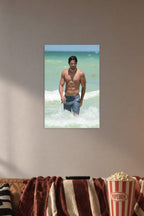 Joe Manganiello in a cozy movie room above a brown sofa with popcorn.