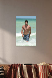 Joe Manganiello in a cozy movie room above a brown sofa with popcorn.