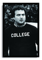 John Belushi as Bluto Blutarsky framed wall art print features a monochrome portrait in a black COLLEGE sweatshirt.