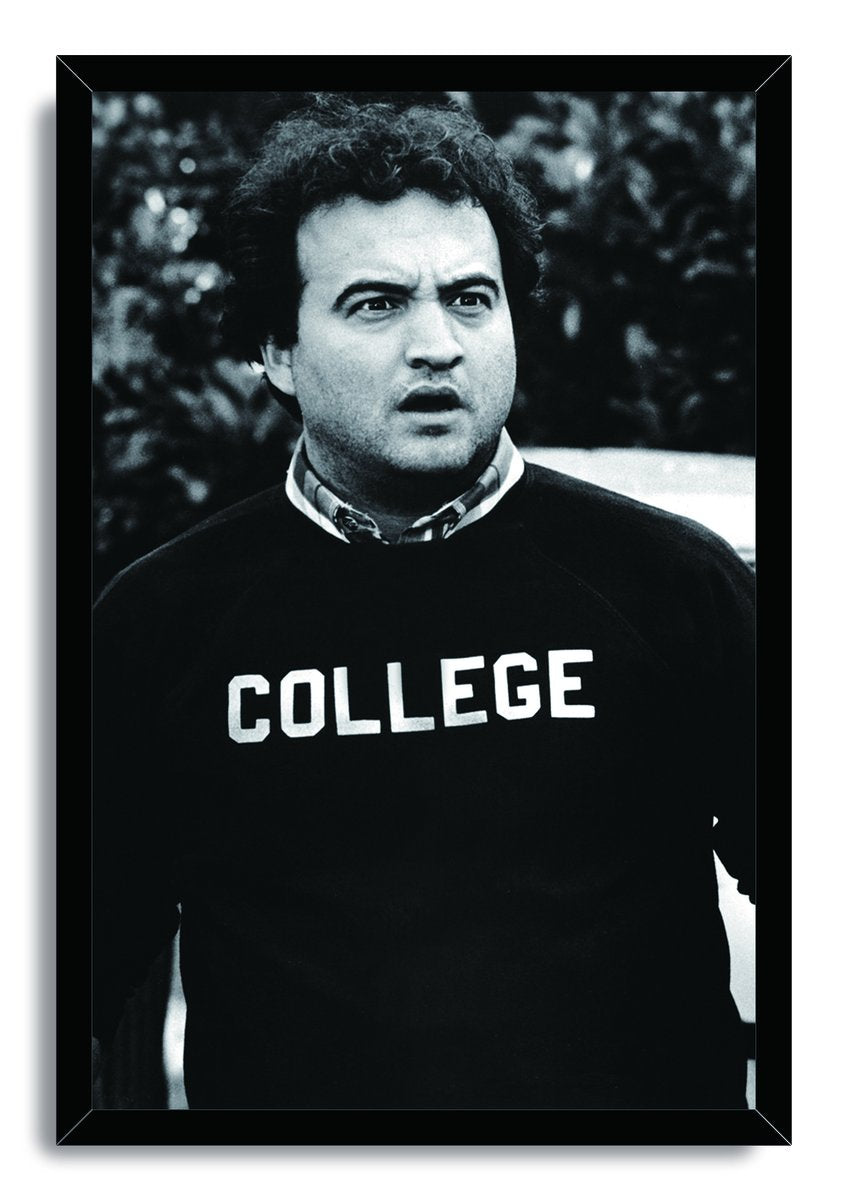 John Belushi as Bluto Blutarsky framed wall art print features a monochrome portrait in a black COLLEGE sweatshirt.