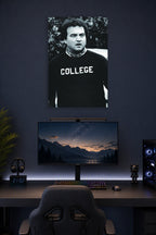 John Belushi as Bluto Blutarsky from Animal House in a gaming desk setup above a monitor.