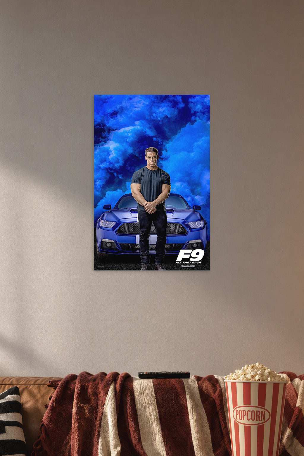 John Cena F9 Movie in a cozy movie room above a brown sofa with popcorn.