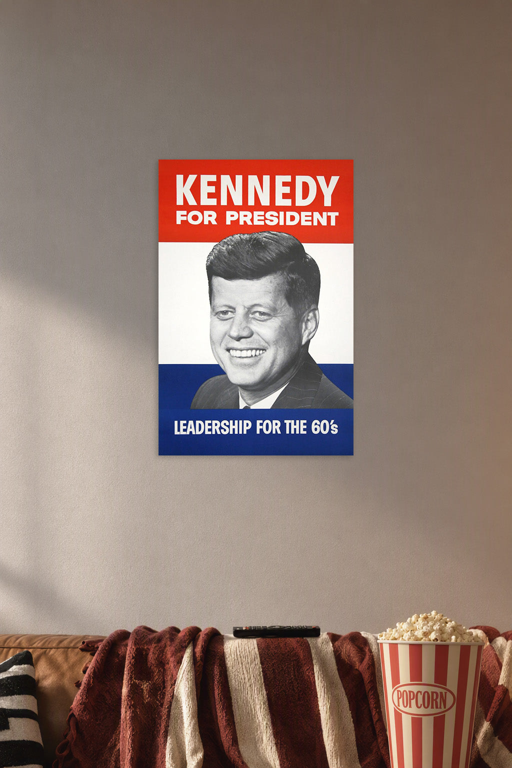 John F. Kennedy JFK Campaign Poster in a cozy movie room above a brown sofa with popcorn.