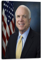 John McCain canvas wall art print displaying a smiling portrait in a pinstripe suit beside a softly blurred U.S. flag.