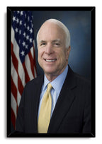 John McCain framed wall art print featuring his formal portrait, yellow tie, dark suit, and American flag against blue-gray.