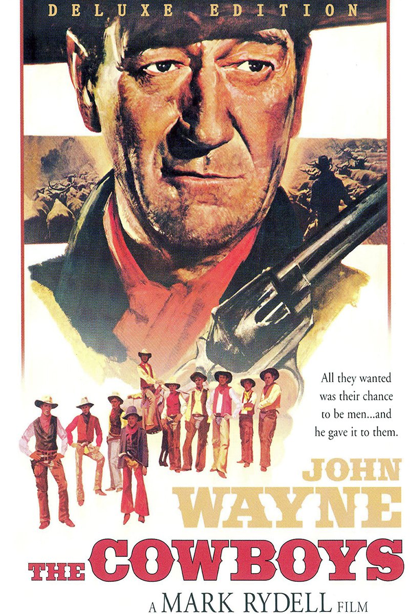 John Wayne The Cowboys poster features a close-up cowboy portrait, rifle, young riders, and bold red Western title text.