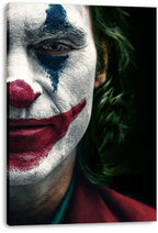 Joker canvas wall art print displaying a close-up clown face with white makeup, blue eye paint, red lips, and green hair.