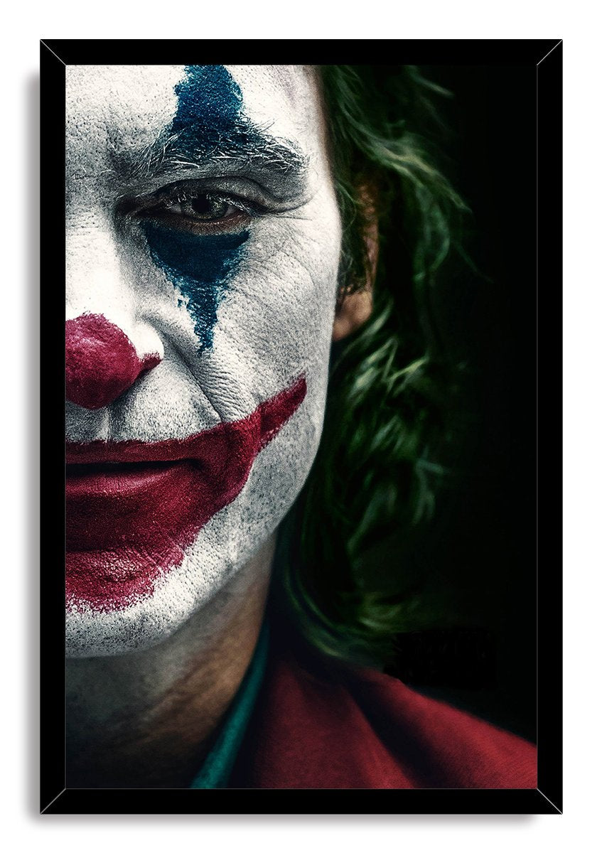 Joker framed wall art print displays an intense half-face portrait in white, blue, red, and green makeup within a slim black frame.