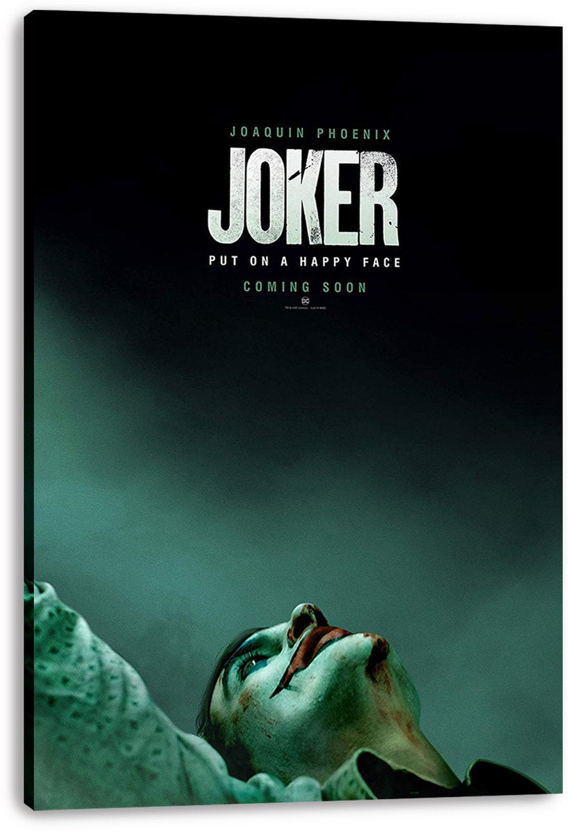 Joker canvas wall art print displays Joaquin Phoenix in clown makeup reclining beneath bold white film title lettering.