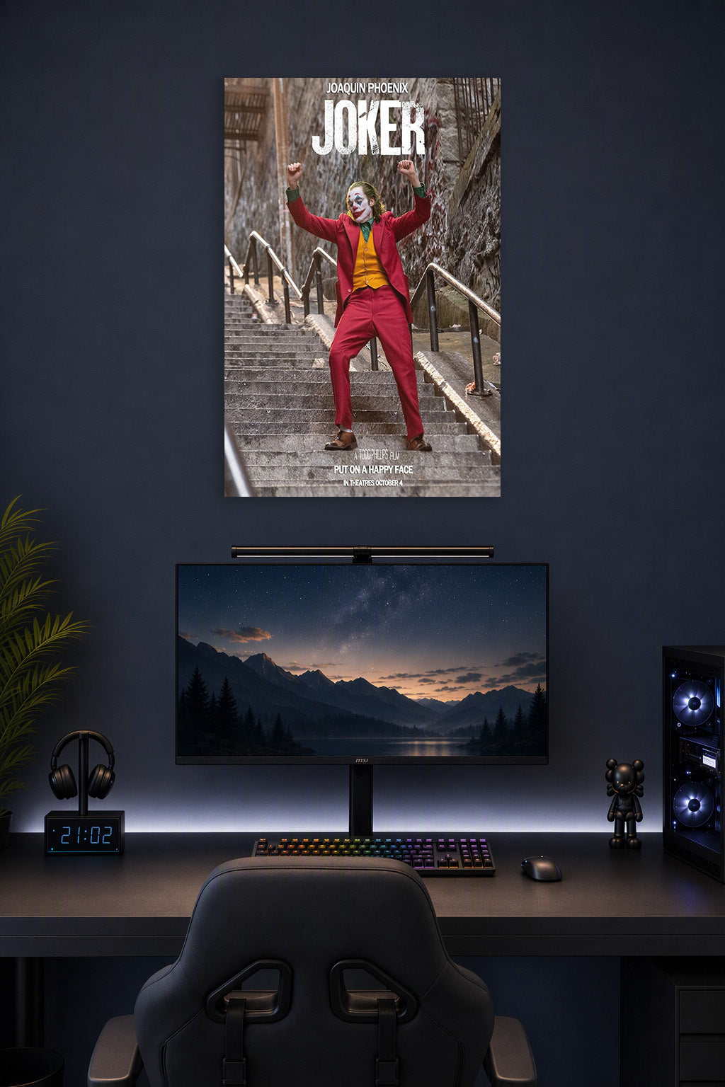 Joker Joaquin Phoenix in a gaming desk setup above a monitor.