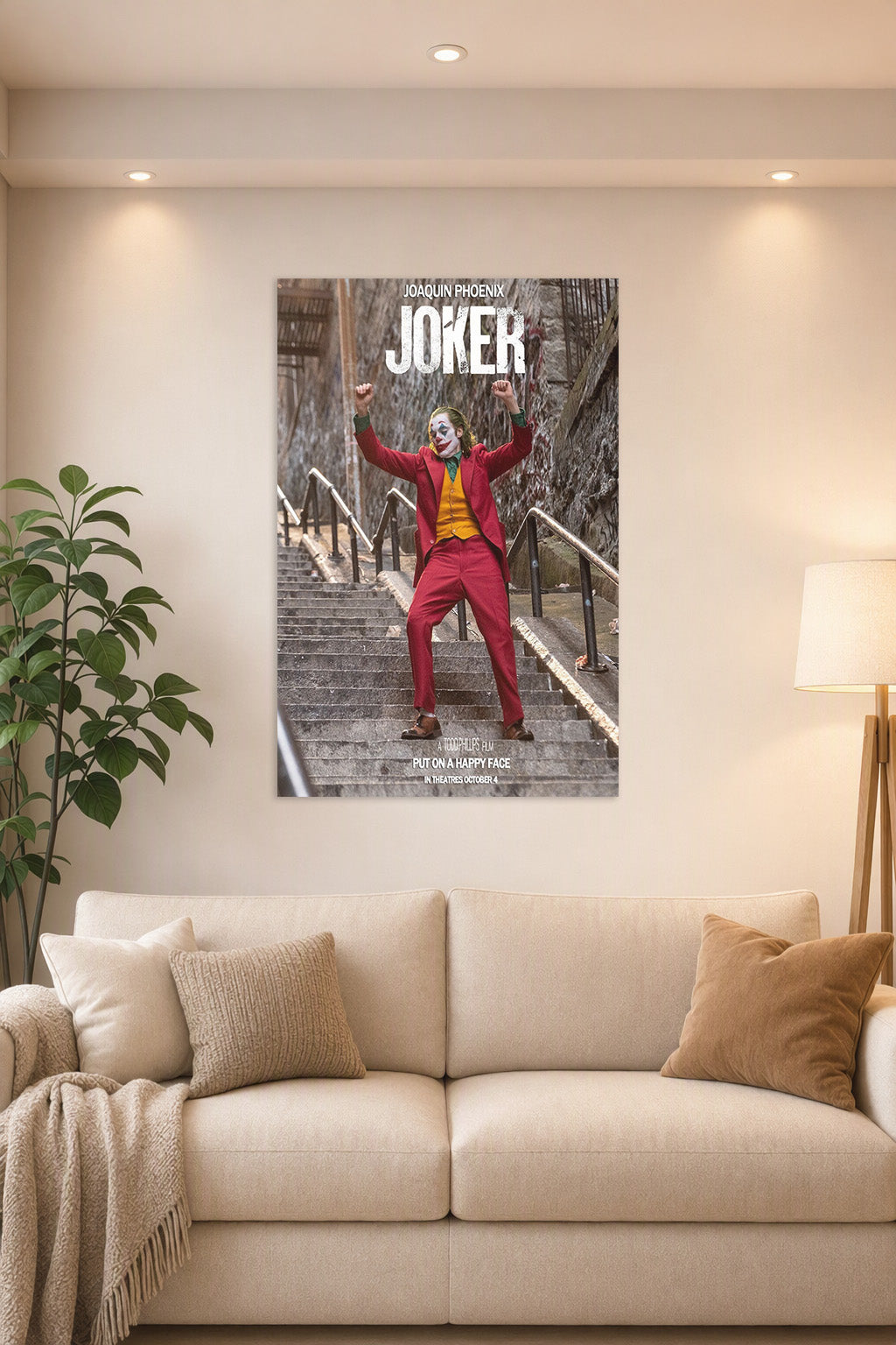 Joker Joaquin Phoenix in a bright living room above a beige sofa.