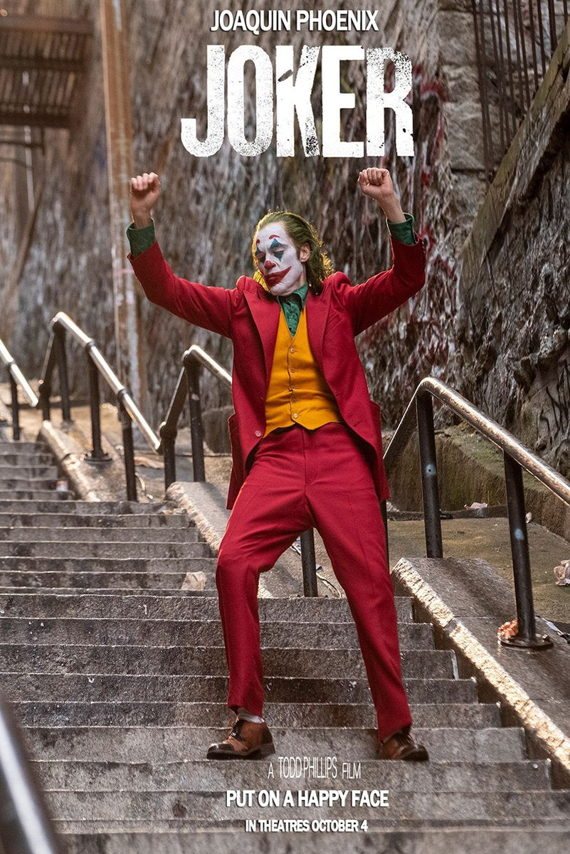 Joker poster features Joaquin Phoenix in clown makeup dancing on concrete stairs in a red suit and yellow vest.