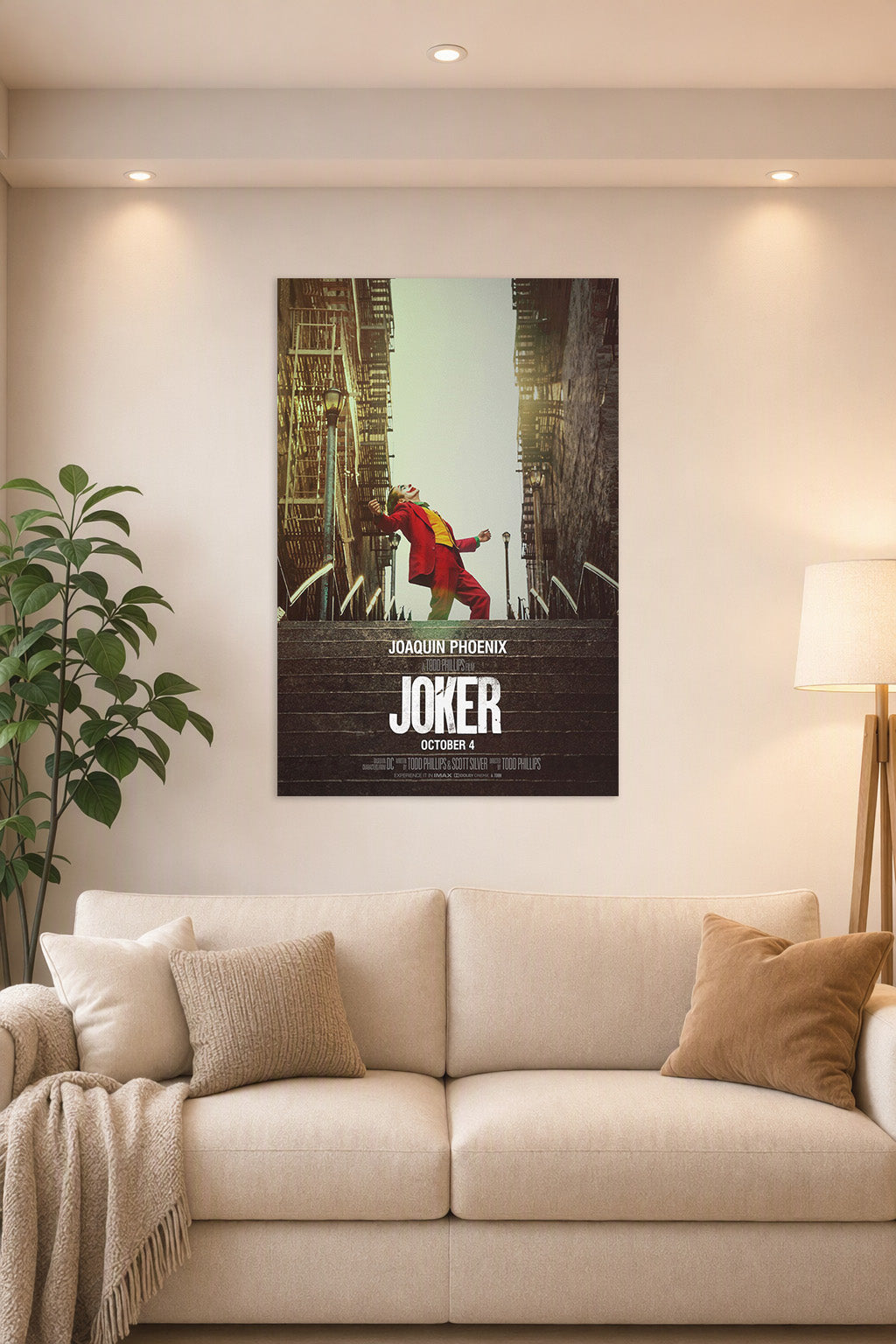 Joker (Joaquin Phoenix) in a bright living room above a beige sofa.